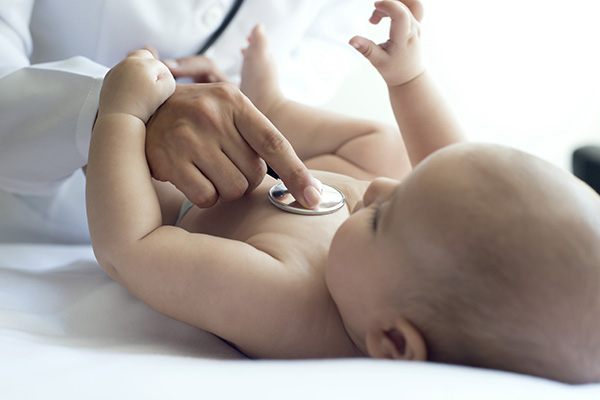 A baby being examined by a doctor