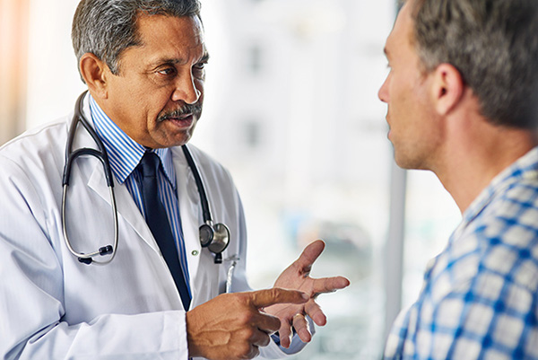 A doctor speaking to a patient